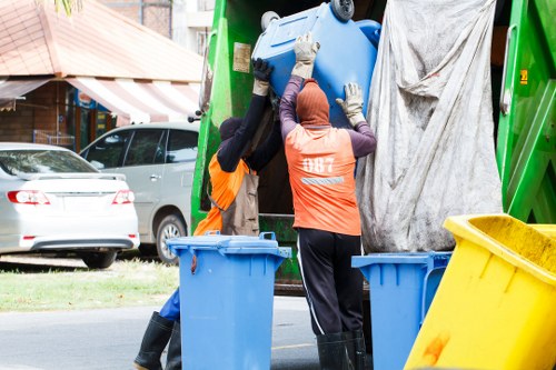 Trained waste handlers wearing PPE and following procedures